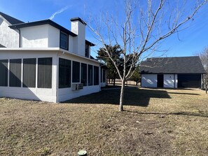 A modern two-story house with large windows and a covered patio area. - Experience Elegance at our Luxury Ranch with New Pool & Deck (Celina)