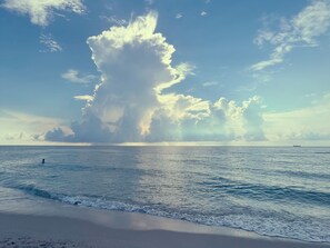 A beach with a large cloud formation and calm sea. - Ocean view stunning PH terrace on ocean dr 2b 2bath (Miami Beach)