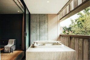 Enjoy a clean and contemporary bathroom with a large sink, natural light, and a view of the surrounding greenery.