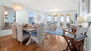 A spacious living room with a dining area, large windows, and a view of the ocean. - SPECTACULAR, LUX, BEACHFRONT Villa/ WOW Views/Steps to Beach & Resort/WIFI/Pool (Galveston)