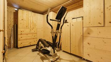 A wooden room with a stationary exercise bike.