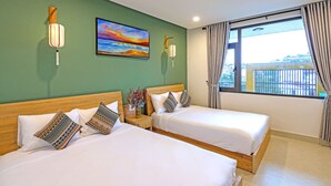 A hotel room with two beds, a painting on the wall, and a window with curtains. - HOIANIAN CENTRAL VILLA (Da Nang)
