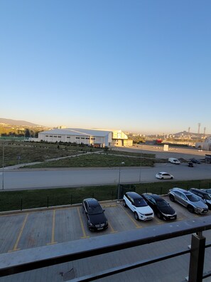 Adjacent to a large industrial building, this parking area offers convenient access to a main thoroughfare.