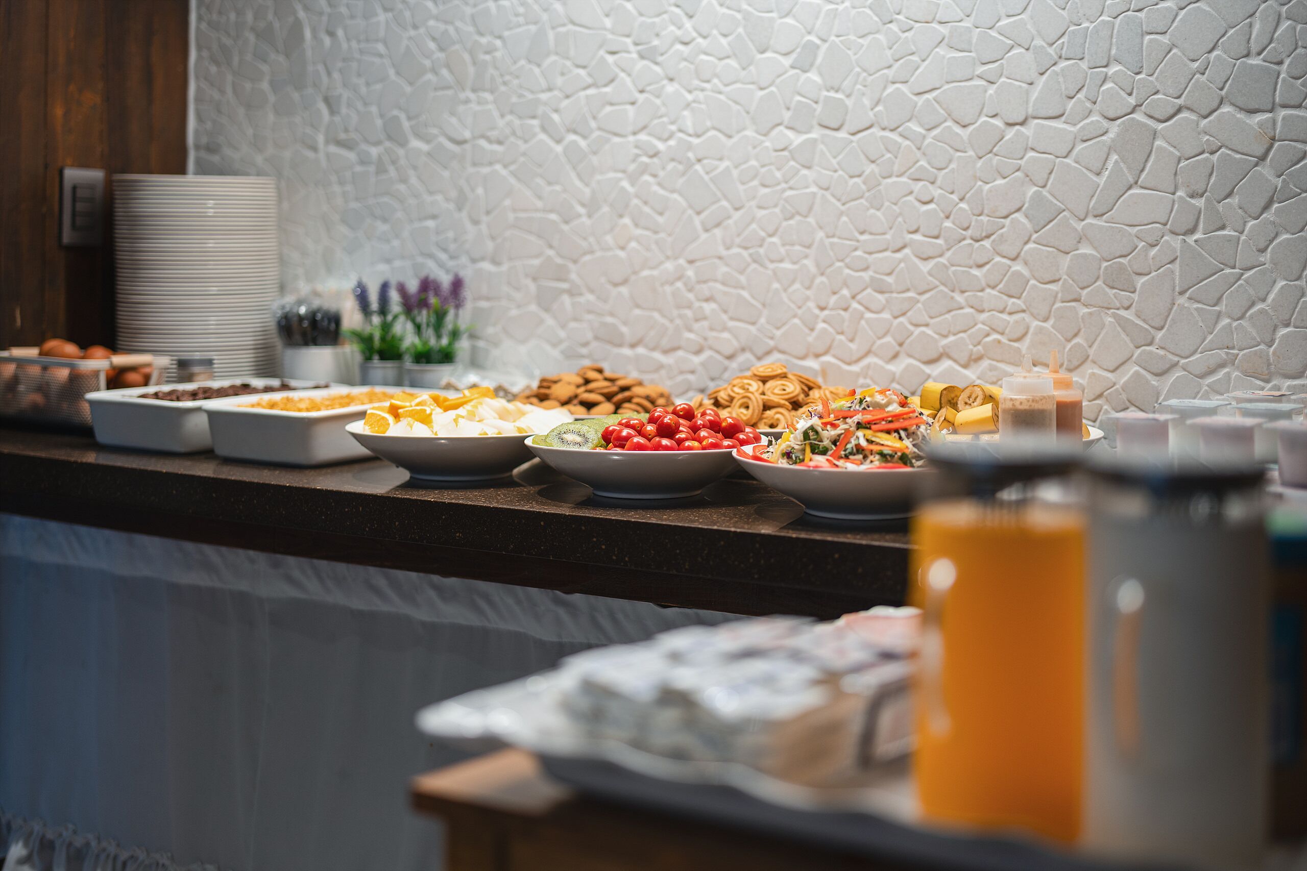 A buffet with various food items and condiments.