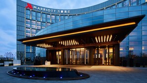 A modern Marriott hotel with a curved facade, large glass windows, and a well-lit entrance. - Nantong Marriott (Nantong)