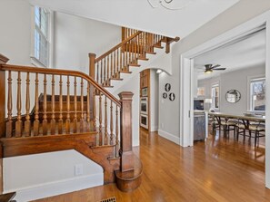 Stunning interior with a grand staircase, dining area, and kitchen.