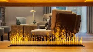 A modern living room with a sofa and a table with a fire feature. - A-ROSA Tegernsee (Tegernsee)