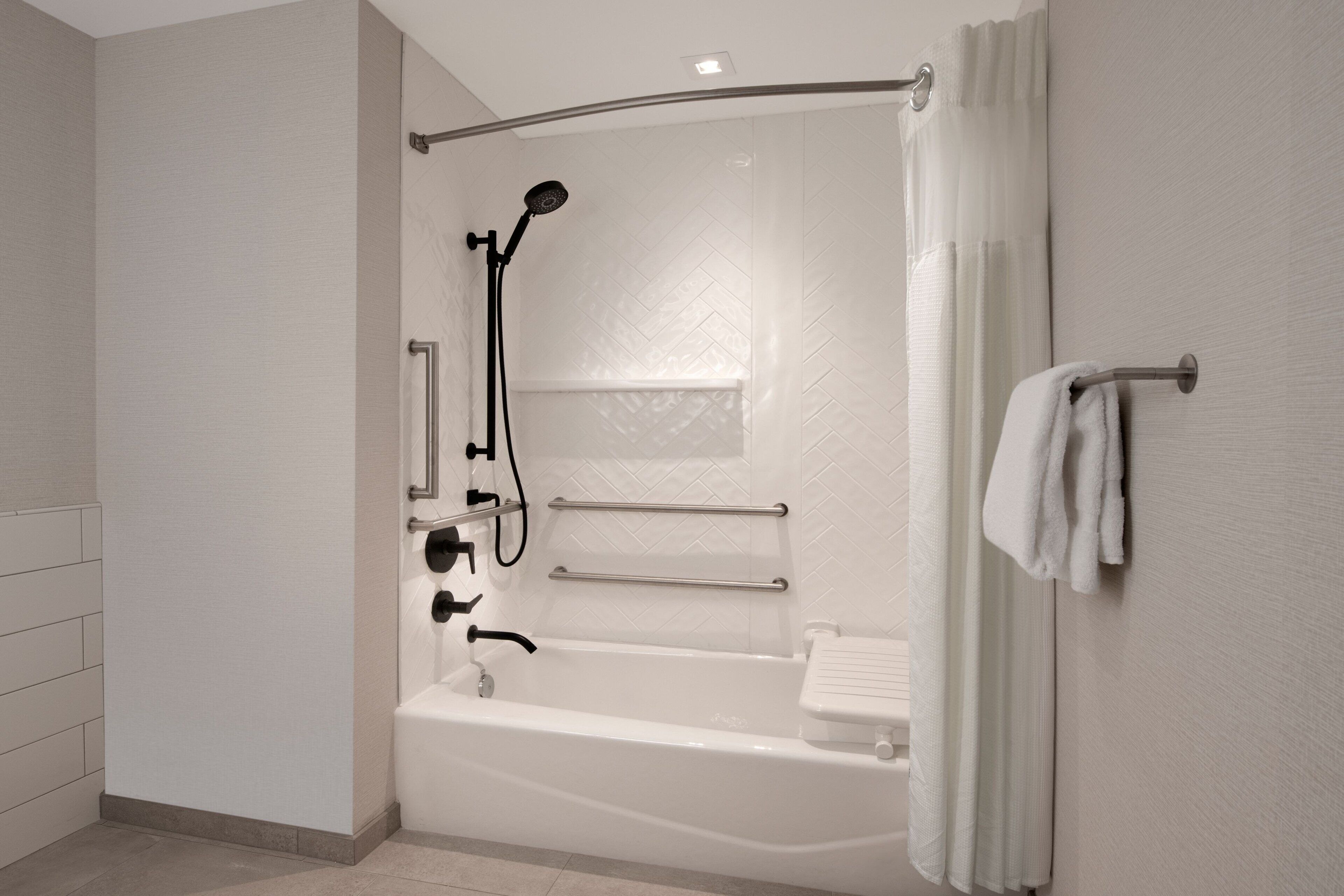 A modern bathroom with a walk-in shower, a bathtub, and a toilet.