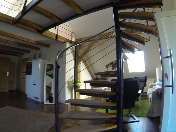 A spiral staircase with wooden beams and a modern interior. - Haus Hannemann, enjoy Rügen in peace and quiet, good location for cycling tours, pets possible (Poseritz)