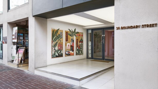 A modern building with a sign for 'Weave Studios' on the ground floor. There are large windows on the upper floor, and a brick-paved entrance. - Weave Studios - Prince Edward (Kowloon)