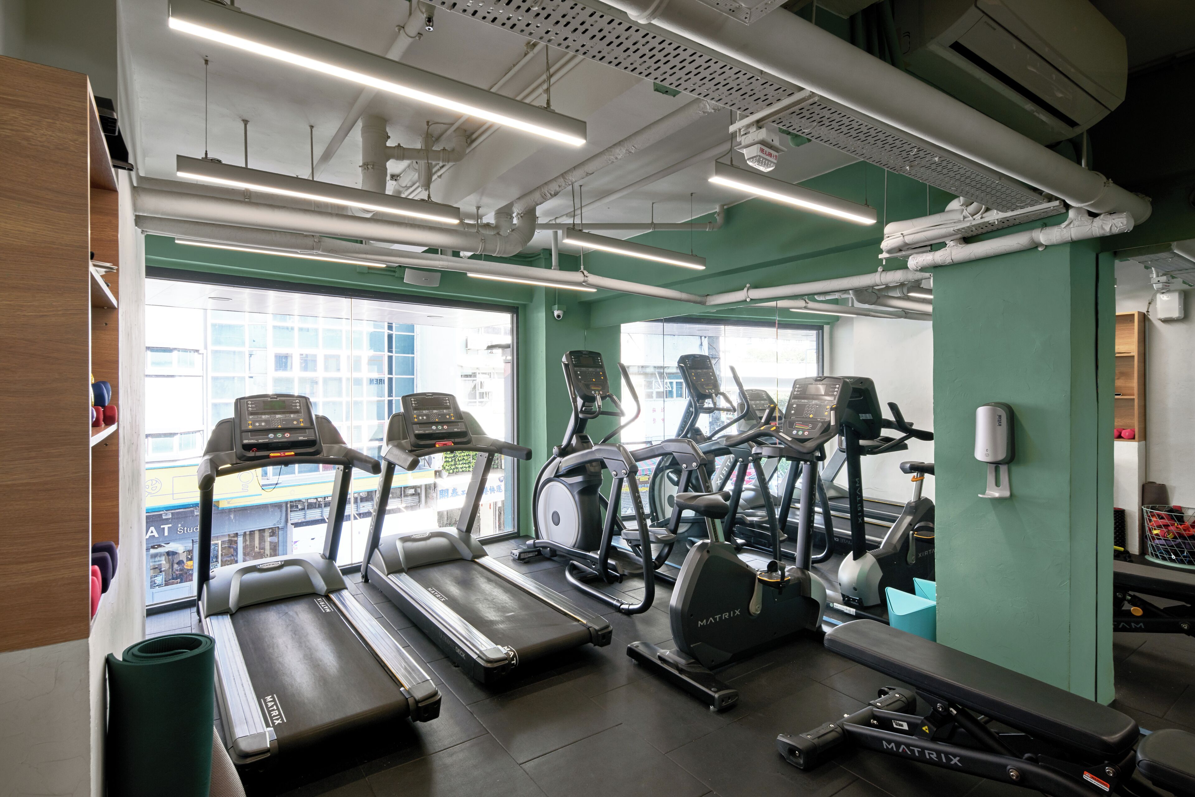 A gym with treadmills, stationary bikes, and a rowing machine.
