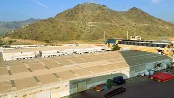 A large industrial warehouse with a flat roof and multiple loading docks.