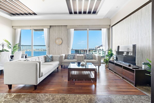 A modern living room with a sofa set, a coffee table, and a TV.