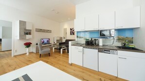 A modern kitchen with white cabinets, a microwave, coffee maker, and a dishwasher. - Apartment No. 13 in Vienna near Schönbrunn/Westbahnhof | Keyless Check-In (Wien)
