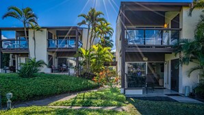 A modern hotel with a pool, outdoor seating, and lush landscaping. - Hale Kamaole #170, Fully Renovated, Ground Floor, Full A/C, Near Kamaole III (Kihei)