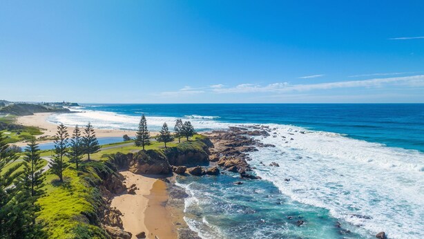 A coastal landscape with a beach, rocky shoreline, and greenery. - 1/15 Dalmeny Drive, Kianga (Kianga)