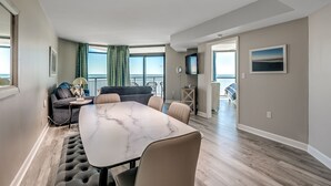 A modern living room with a marble table, leather chairs, a sofa, and a TV. - 🌊Newly Renovated Oceanfront | Awesome Amenities | Caribbean Resort 803🌊 (Myrtle Beach)