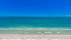 Ein Strand mit klarem türkisblauem Wasser und einem sandigen Ufer.