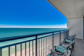 A balcony with a view of the ocean, equipped with several lounge chairs. - 💎Large Oceanfront~Lazy River~Awesome Amenities~ Caribbean Resort 1904💎 (Myrtle Beach)