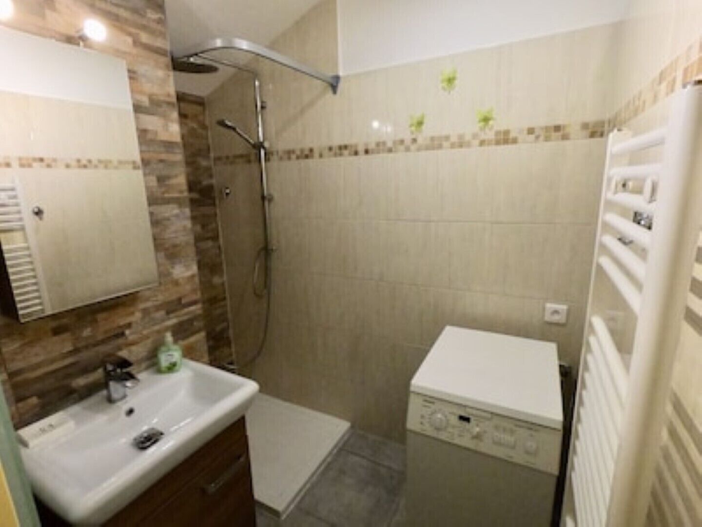 A bathroom with a shower, sink, and a toilet.