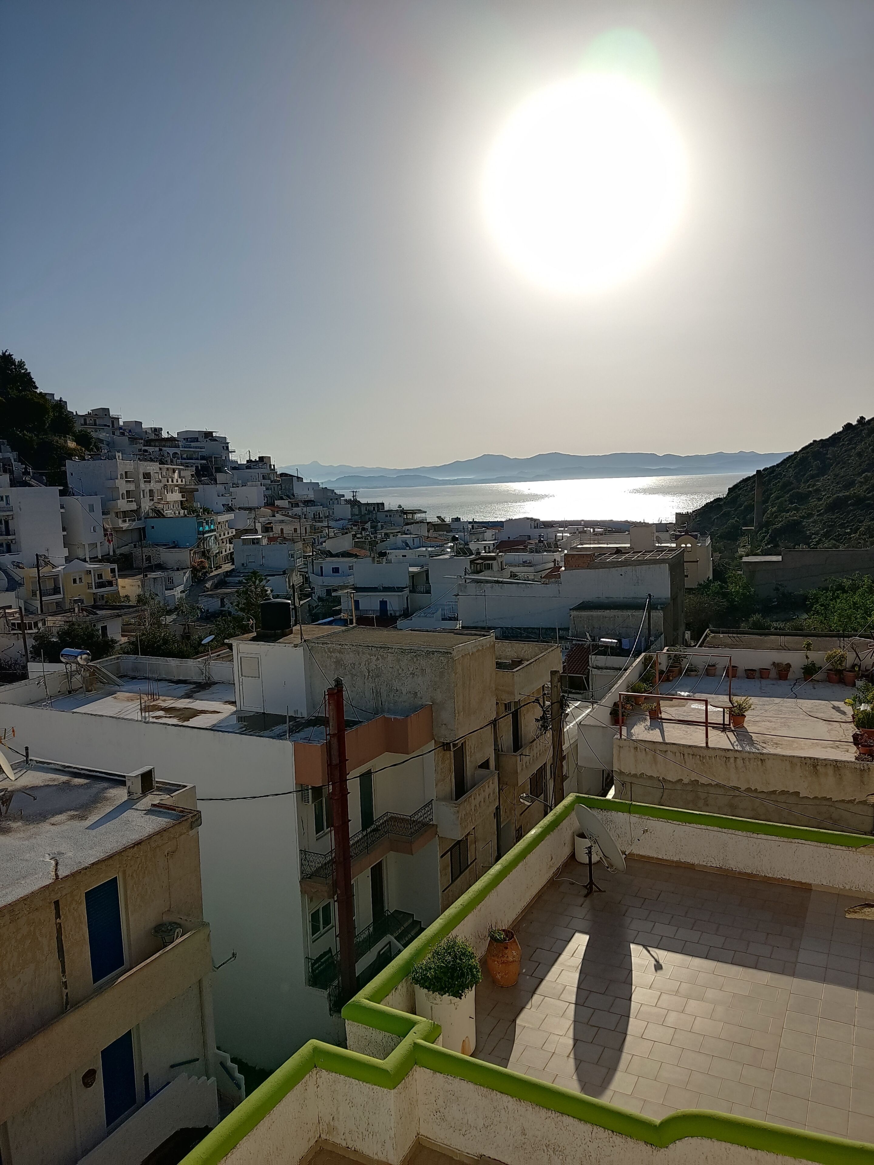 A coastal town with buildings and a sea view.