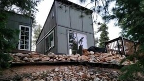 A two-story cabin with a stone foundation and a wooden deck. - Unique Property in the Southern Utah Mountains near Duck Creek Village  (Duck Creek Village)