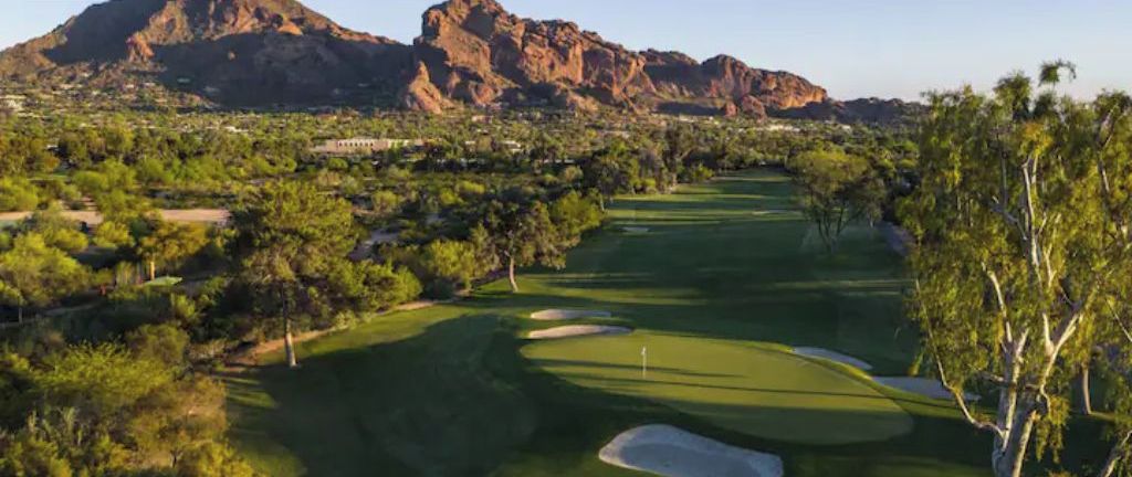 A golf course with a mountain in the background.
