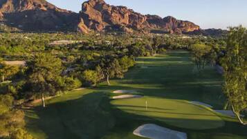 A golf course with a mountain in the background.