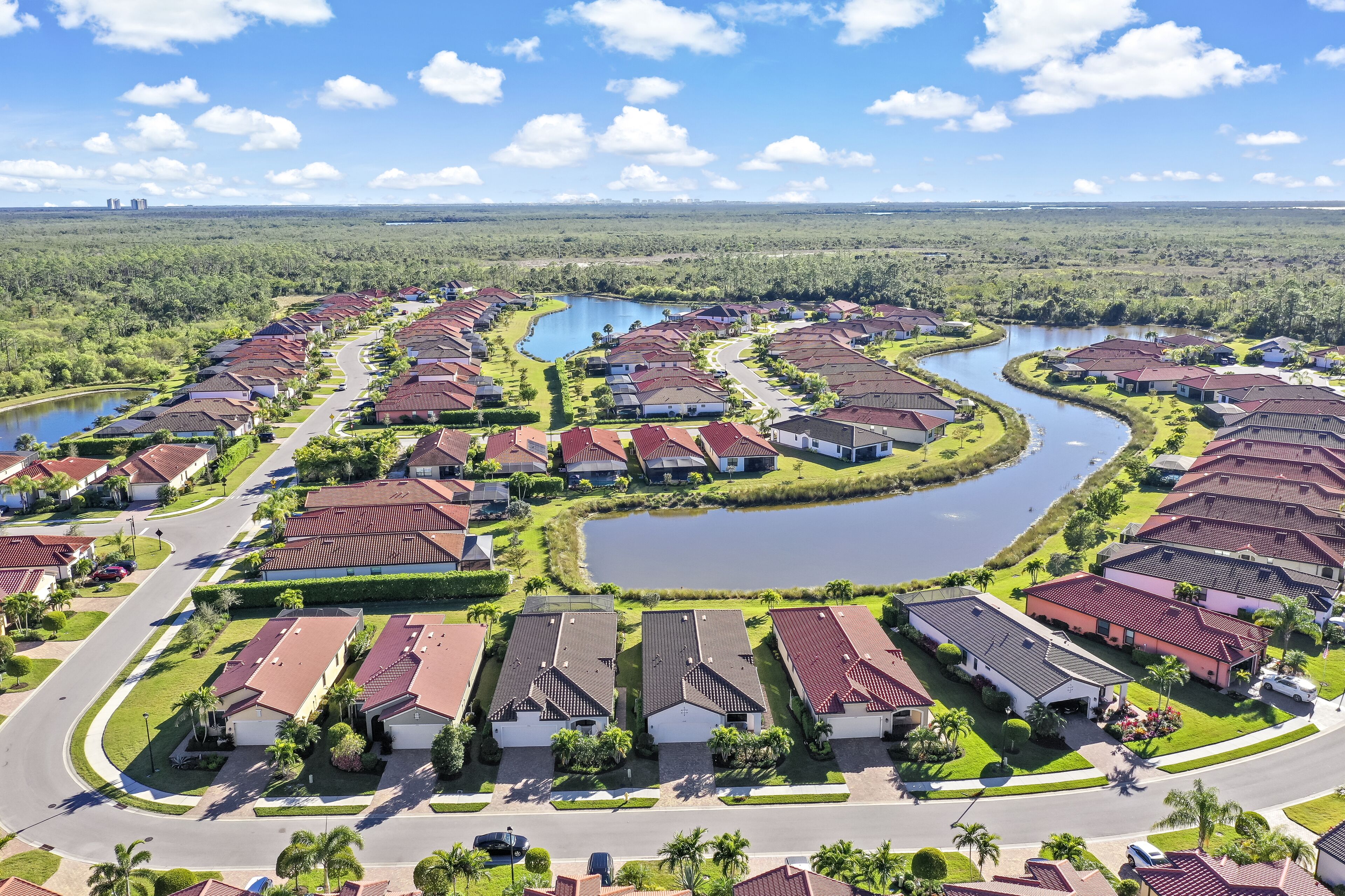 A residential area with houses arranged in a curved layout around a central water feature.