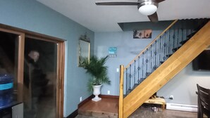 A staircase with wooden railings and a ceiling fan.