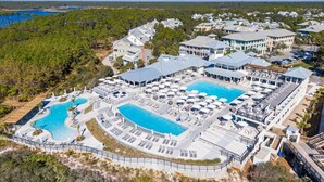 An aerial view of a resort with multiple swimming pools, lounge areas, and a large building complex. - Luxurious WaterColor House Minutes From Seaside and the Beach! (Santa Rosa Beach)