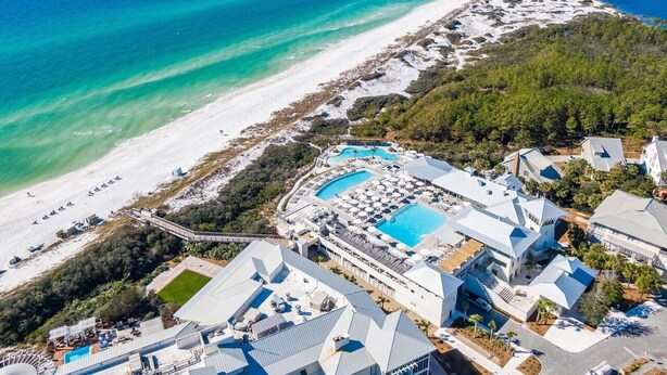 An aerial view of a coastal resort with multiple swimming pools, a beach, and a dense forested area. - Luxurious WaterColor House Minutes From Seaside and the Beach! (Santa Rosa Beach)