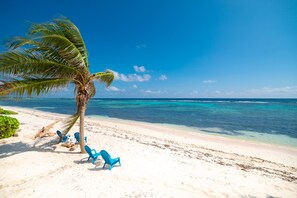 On the beach, sun loungers, beach towels - NEW! Modern Beach/Oceanfront Condo - STUNNING! Seabreeze Villas  (Bodden Town)