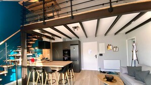 A modern interior with a dining area, kitchen, and living space.