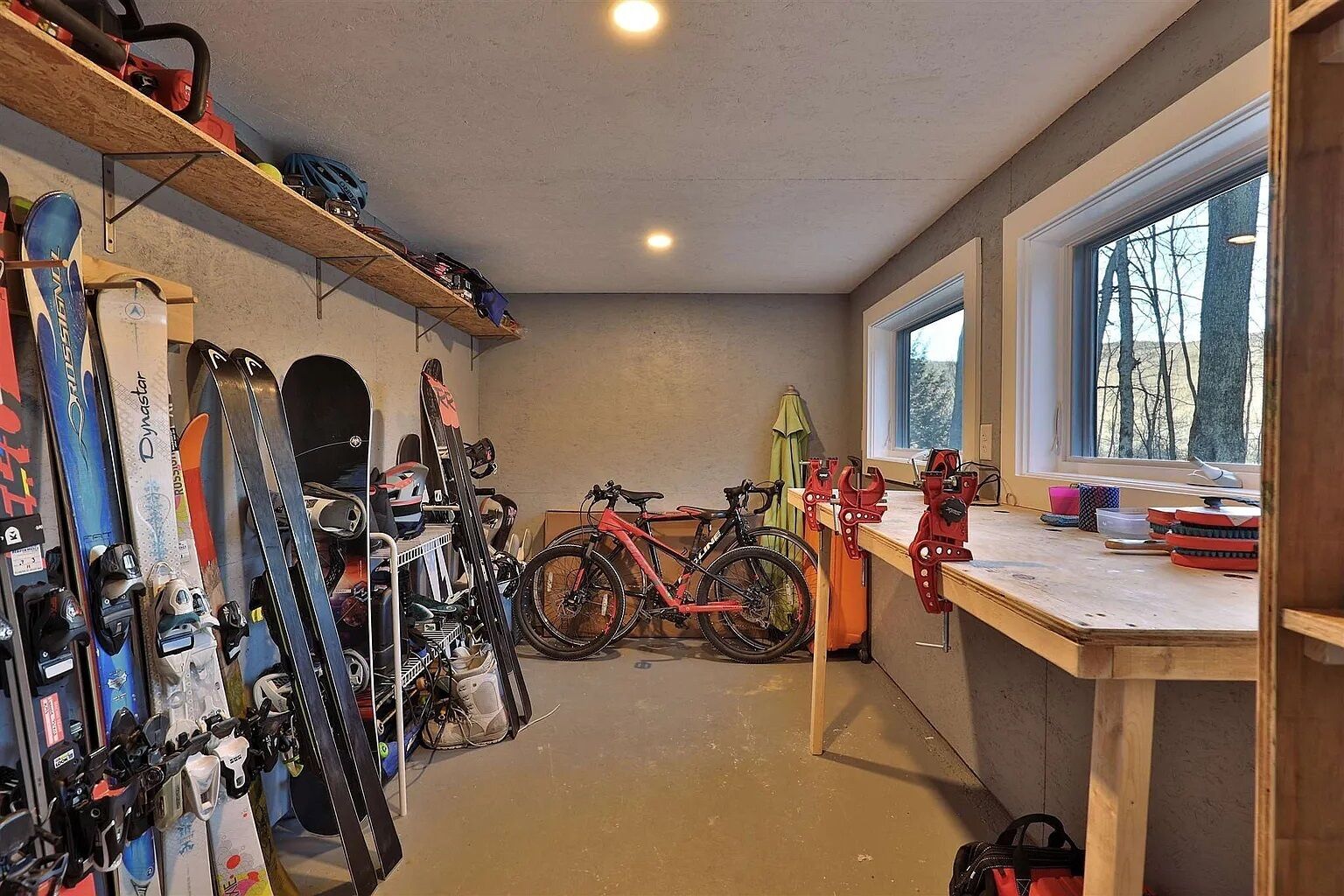 A ski storage area with skis and a bicycle.