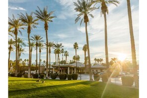 Stunning hotel entrance with a grand lobby and beautifully manicured lawn.