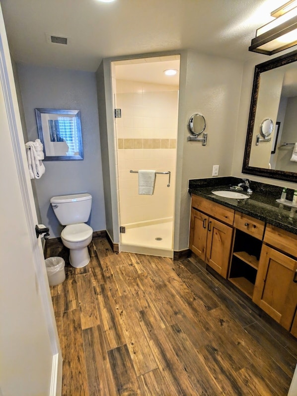 A bathroom with a toilet, sink, and shower.
