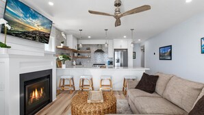 A modern kitchen with white cabinets, a built-in stove, and a large island.