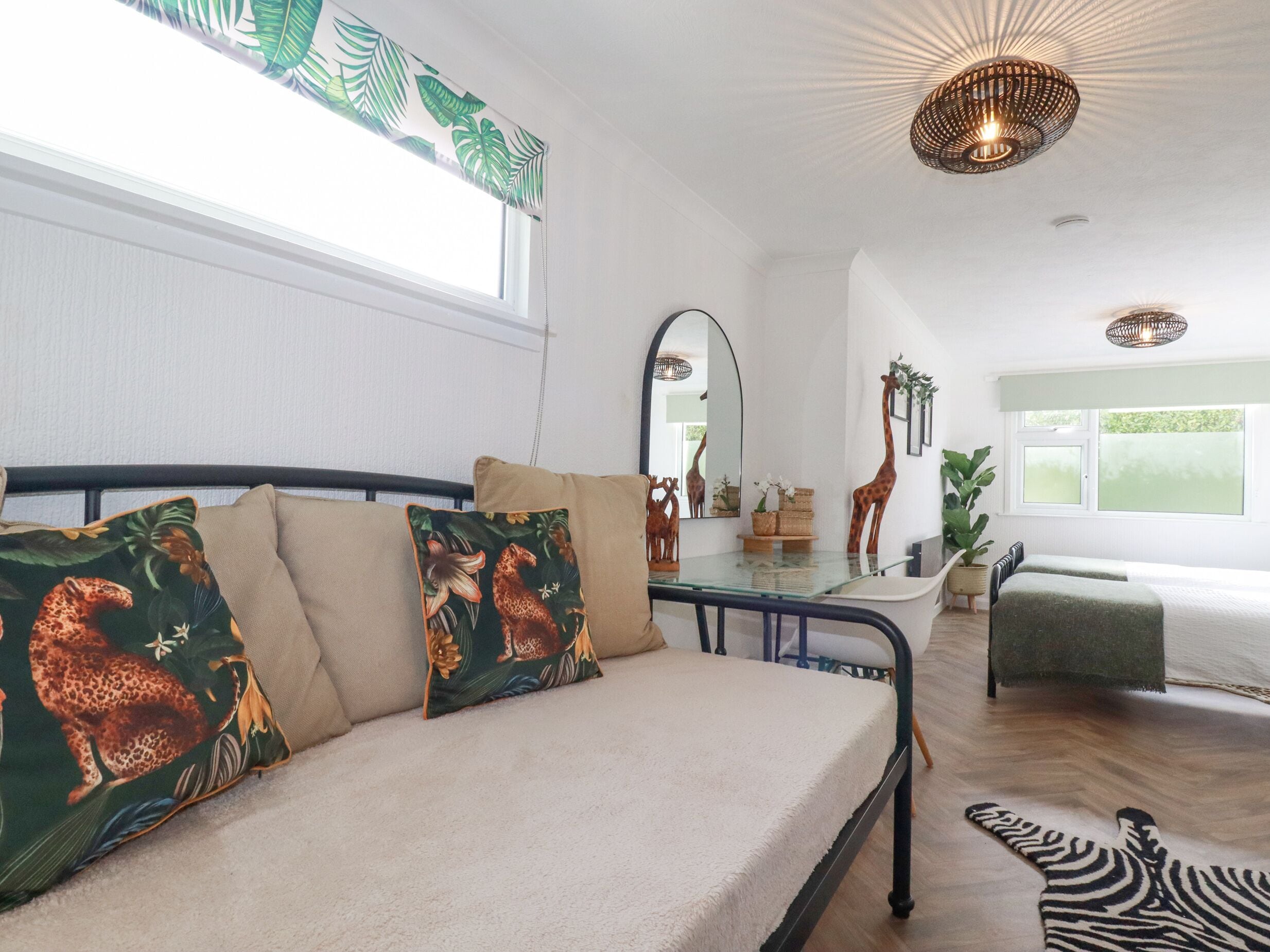 Una habitación amplia con cama, comedor y vistas al exterior.
