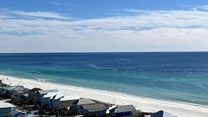 A coastal view with a beach, ocean, and a row of houses with a clear sky. - BEST 🌴Stocked Family❤️ Condo! 🌴16th Floor AMAZING GULF Views ❤️Easy Walk to Beach! (Panama City Beach)