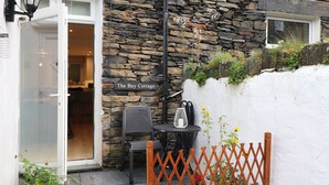 A stone building with a sign reading "The Bay Cottage".