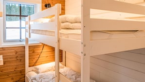 A bunk bed with a window above, wooden walls, and a visible power outlet. - 4 bedroom lovely home in Sysslebäck (Sysslebäck)