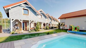 A modern hotel with a swimming pool, multiple guest rooms, and a covered outdoor area. - Gorgeous home in Karwia with heated swimming pool (Karwia)