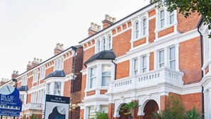 A traditional red brick building with white trim and arched windows. A signboard for 'Blue Piano Restaurant & Bar' is visible in front. - Blue Piano (Birmingham)
