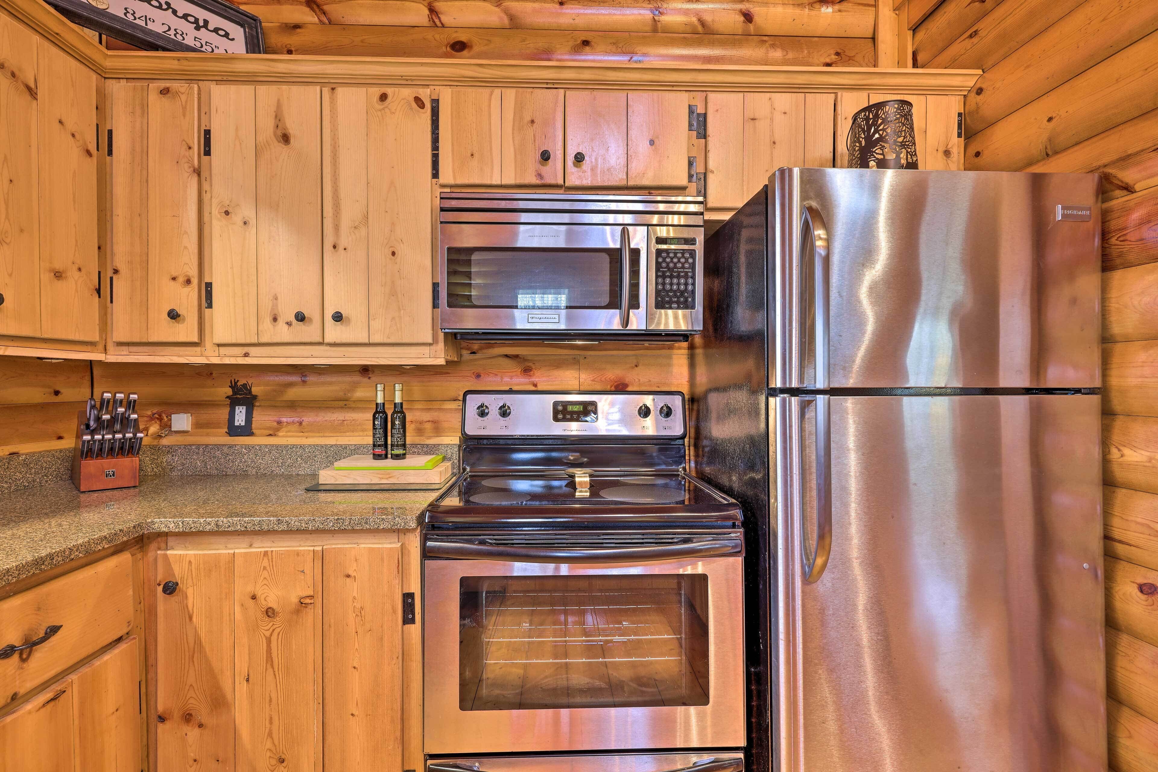 A kitchen with wooden cabinets, a stainless steel microwave, oven, and refrigerator.