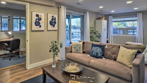 A modern living room with a sofa, coffee table, and artwork on the wall. - 6 Mi to Dtwn Parker: Serene Studio Suite! (Parker)