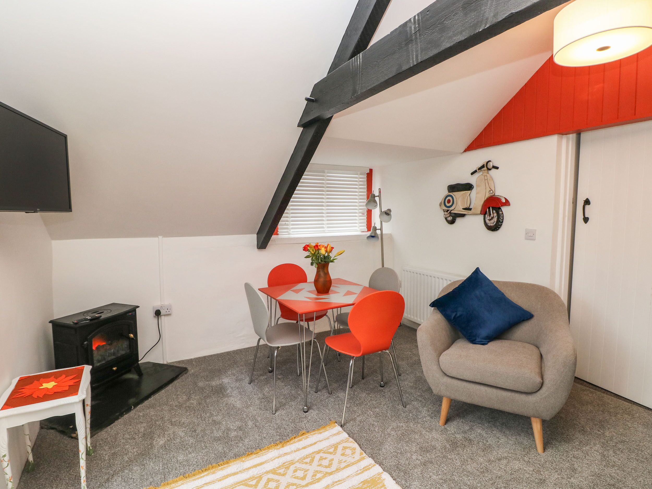 Un espacio habitable compacto con comedor, sofá, mesa pequeña y calefacción.