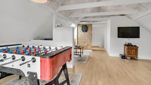 A spacious room with a foosball table, a dartboard, and a television. - 3 bedroom beautiful home in Bryrup (Bryrup)