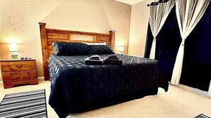 A bedroom with a bed, nightstands, and a window with curtains. - Free Water Park! August on Sale Now! (Kissimmee)