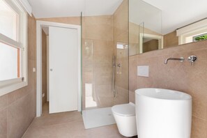 A modern bathroom with a glass shower enclosure, a white toilet, and a large sink. - CAN FONT (COSTITX) - Stunning villa with private pool and free WiFi. (Costitx)